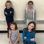 4 students, 2 standing 2 sitting