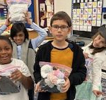 Four kids holding various items