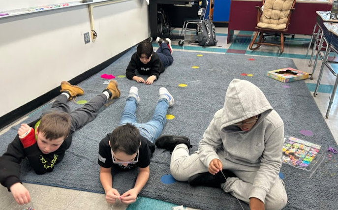 four kids laying down